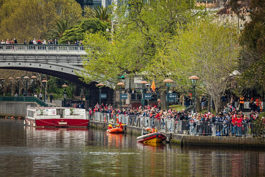Crowds line the banks of the Yarra River.