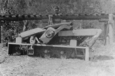 a black and white picture of a locomotive smashed up after an accident