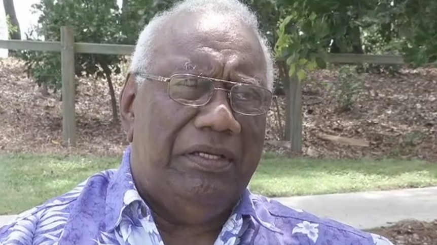 A man of in a colourful shirt speaks to the camera.