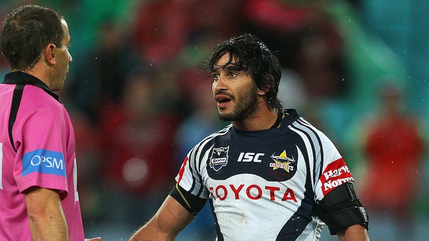 Johnathan Thurston argues with referee Ben Cummins after Souths were awarded the winning penalty at the Olympic stadium.