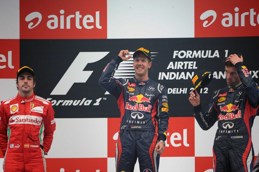 Well on top ... Sebastian Vettel celebrates ahead of Fernando Alonso and Mark Webber