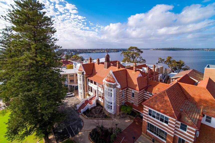 A bird's eye view of Methodist Ladies' College in Claremont with the Swan River in the background and clouds in the distance.