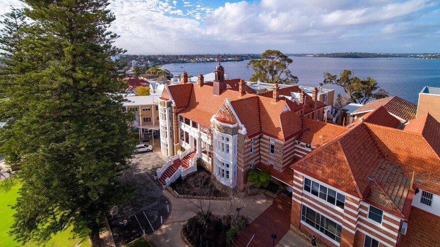 A bird's eye view of Methodist Ladies' College in Claremont with the Swan River in the background and clouds in the distance.