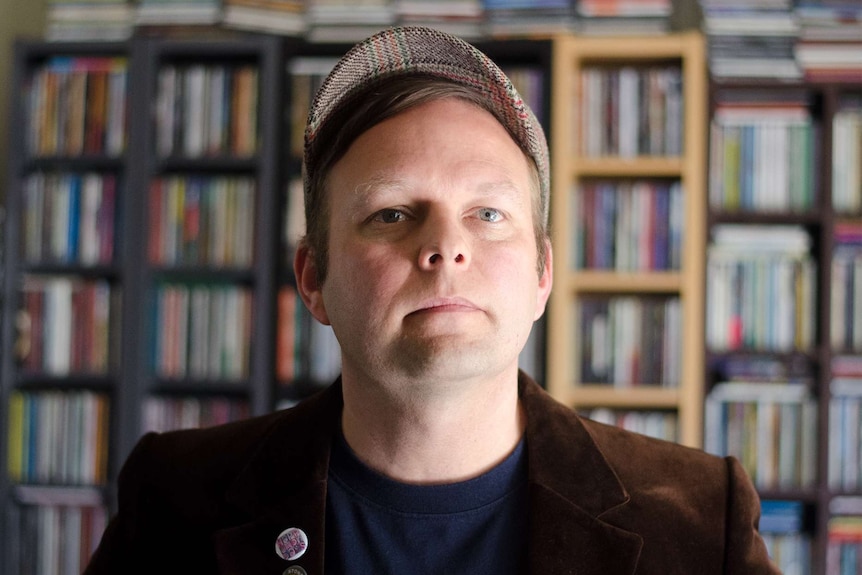 Scott Thurling standing in front of his CD collection