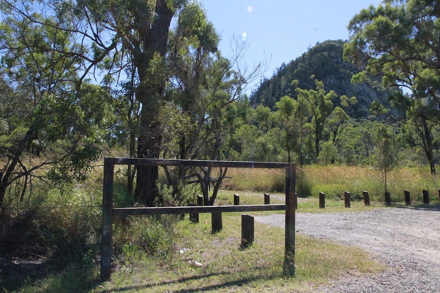 a mountain in the distance with an empty sign