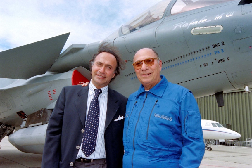 Olivier Dassault and his father Serge pose in front of a fighter jet