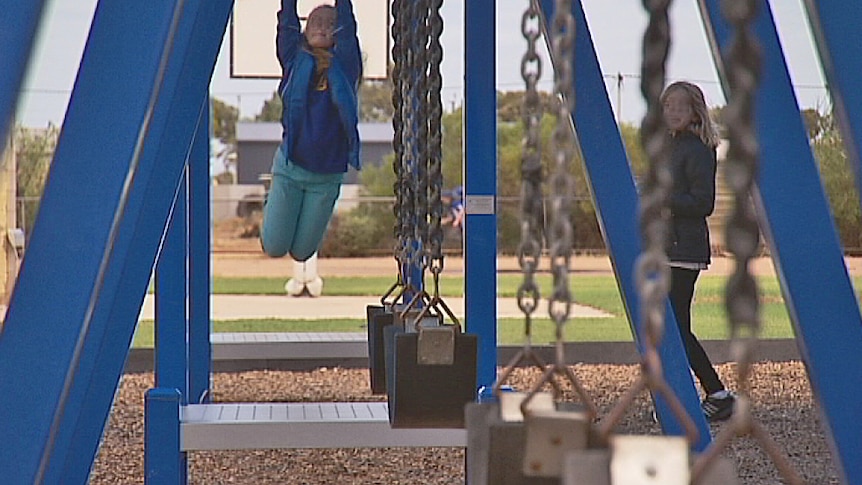 Students on playground equipment at a school