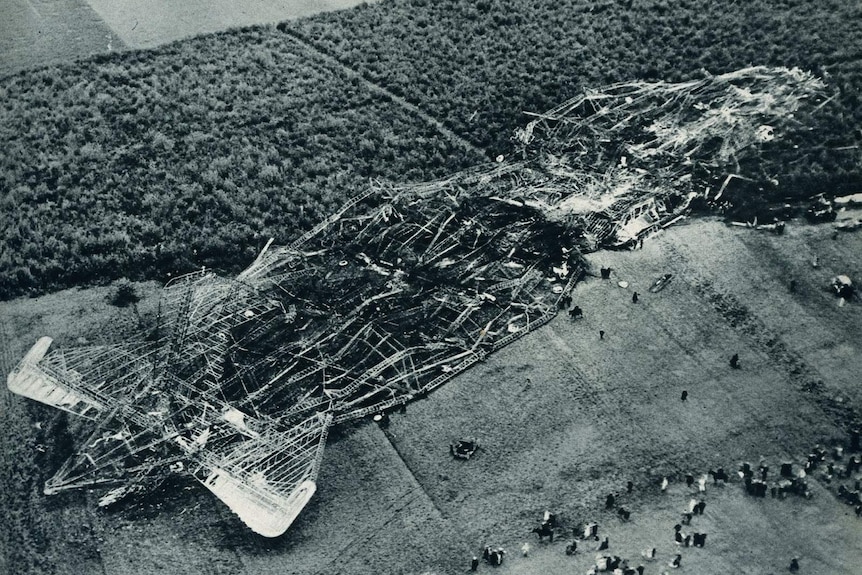 A black and white image of the crashed airship on the ground.