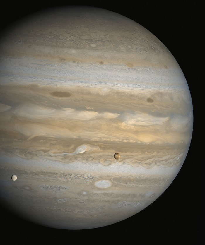 A view of Jupiter, with some of its moons seen in the foreground