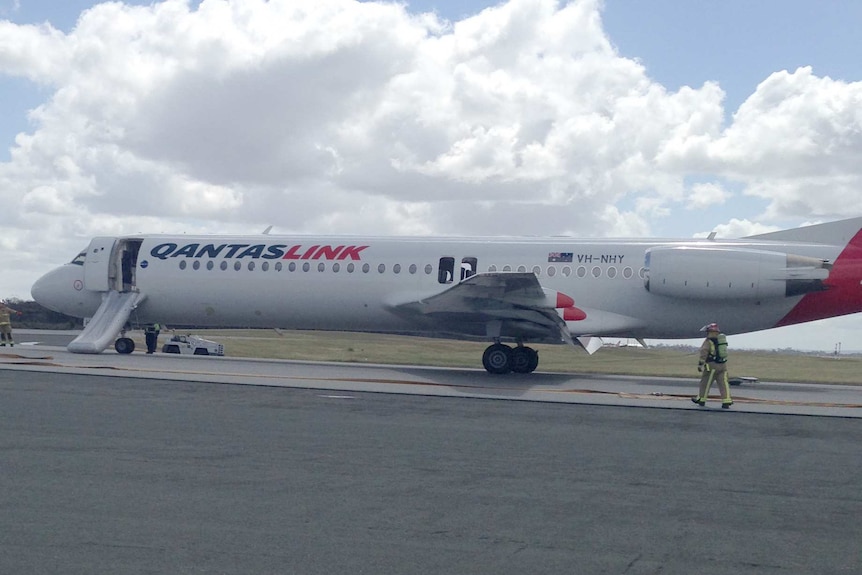 The QantasLink plane on the tarmac at Perth Airport.