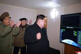 North Korean leader Kim Jong-un watches screen showing an intercontinental ballistic missile test with generals