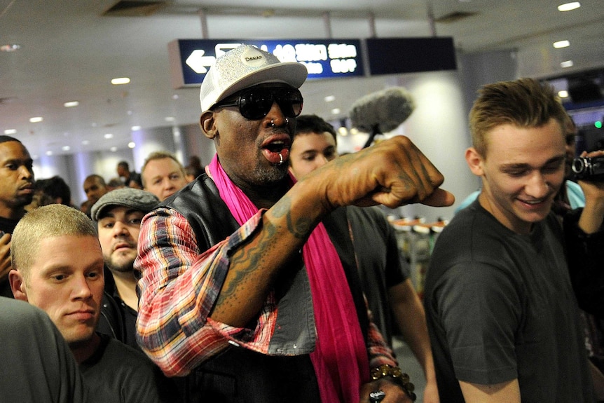 Dennis Rodman checks in for flight to North Korea.