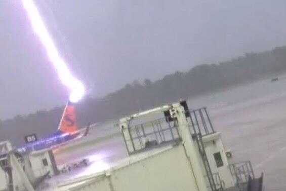 Lightning hitting the rear of a blue Sun Country plane on the tarmac at Fort Myers, Florida