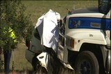 A 4wd lodged under a truck after a head-on in Launceston