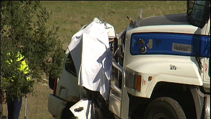 A 4wd lodged under a truck after a head-on in Launceston