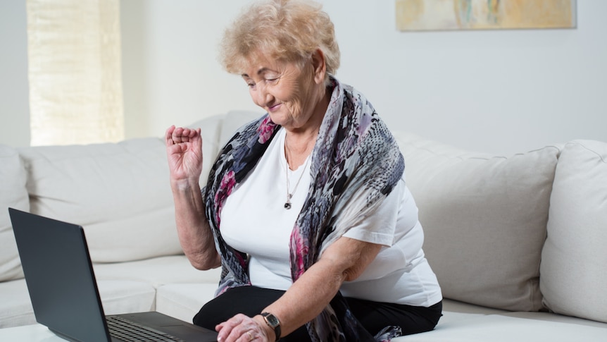 A picture of a grandmotherly woman using a laptop