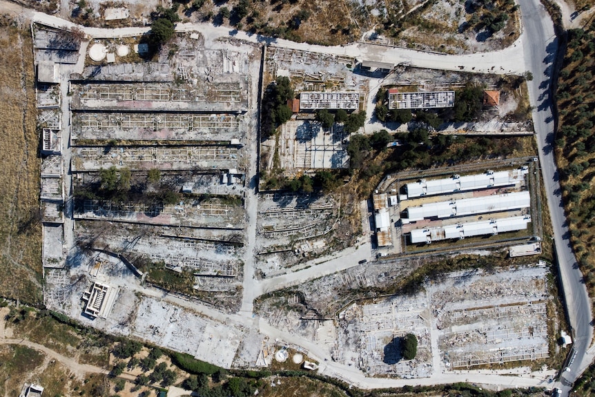 An aerial view of the destroyed Moria camp shows a patchwork of burnt out dwellings.