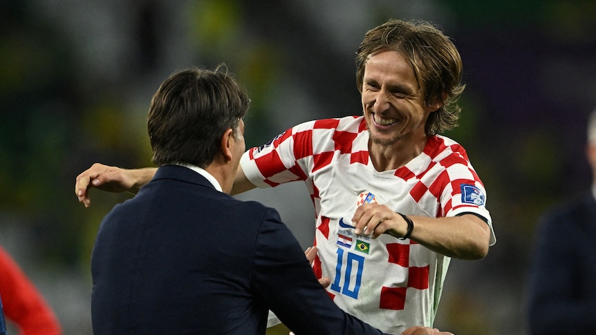 Luka Modric celebrates with Zlatko Dalic after defeating Brazil