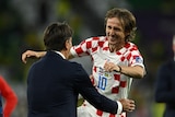 Luka Modric celebrates with Zlatko Dalic after defeating Brazil
