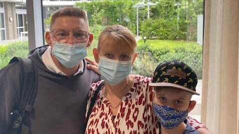Father, mother and son wearing masks