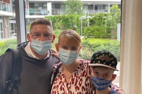 Father, mother and son wearing masks