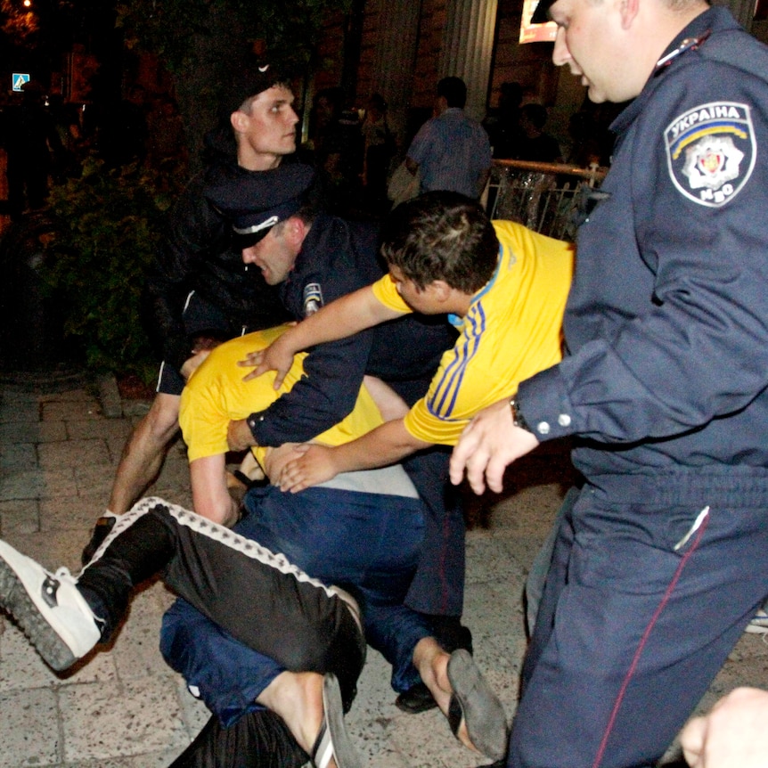 Police intervene as Russian and Ukrainian soccer fans fight after the Russia v Czech Republic game.
