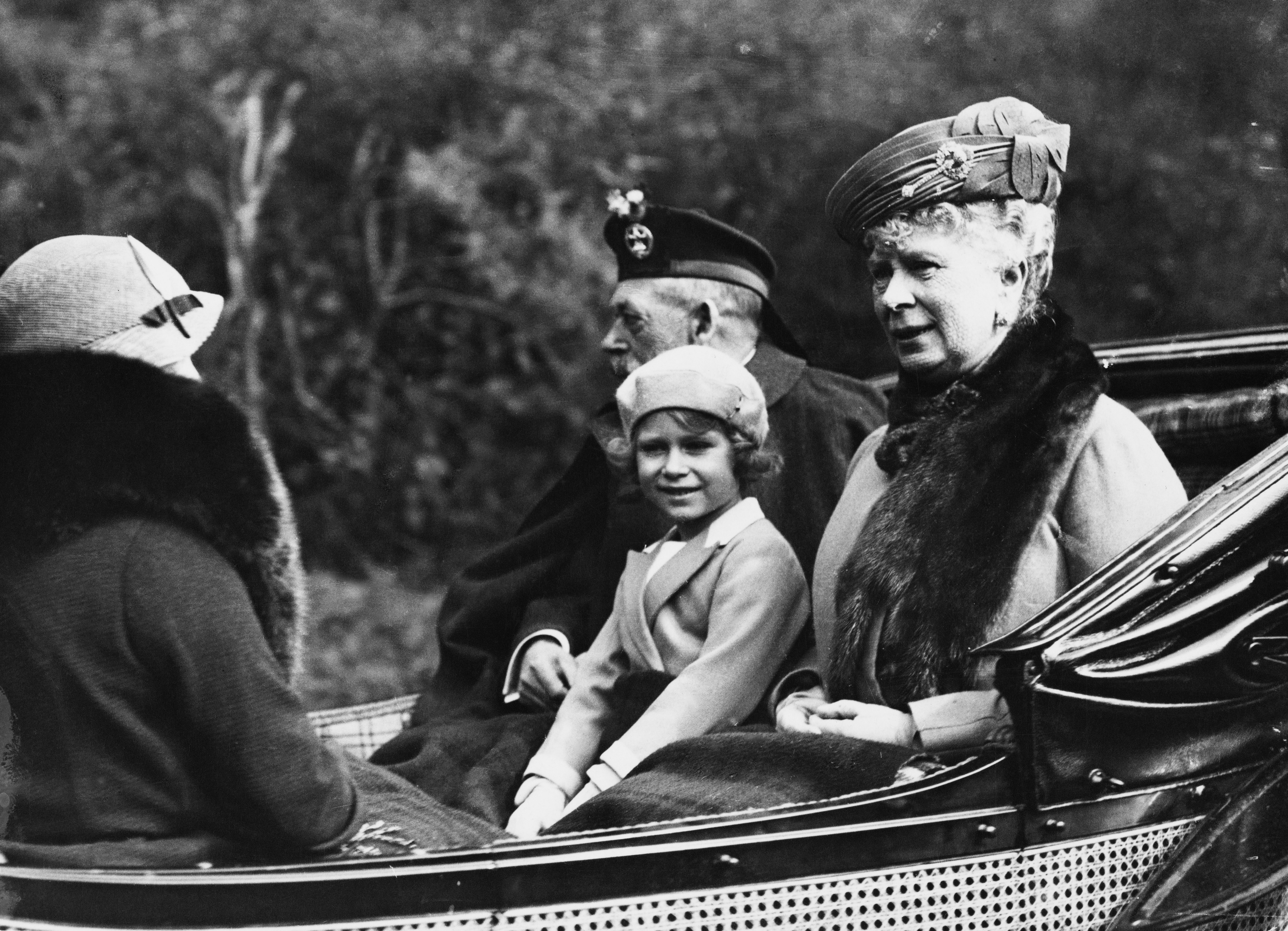 A woman and a little girl in an open top carriage