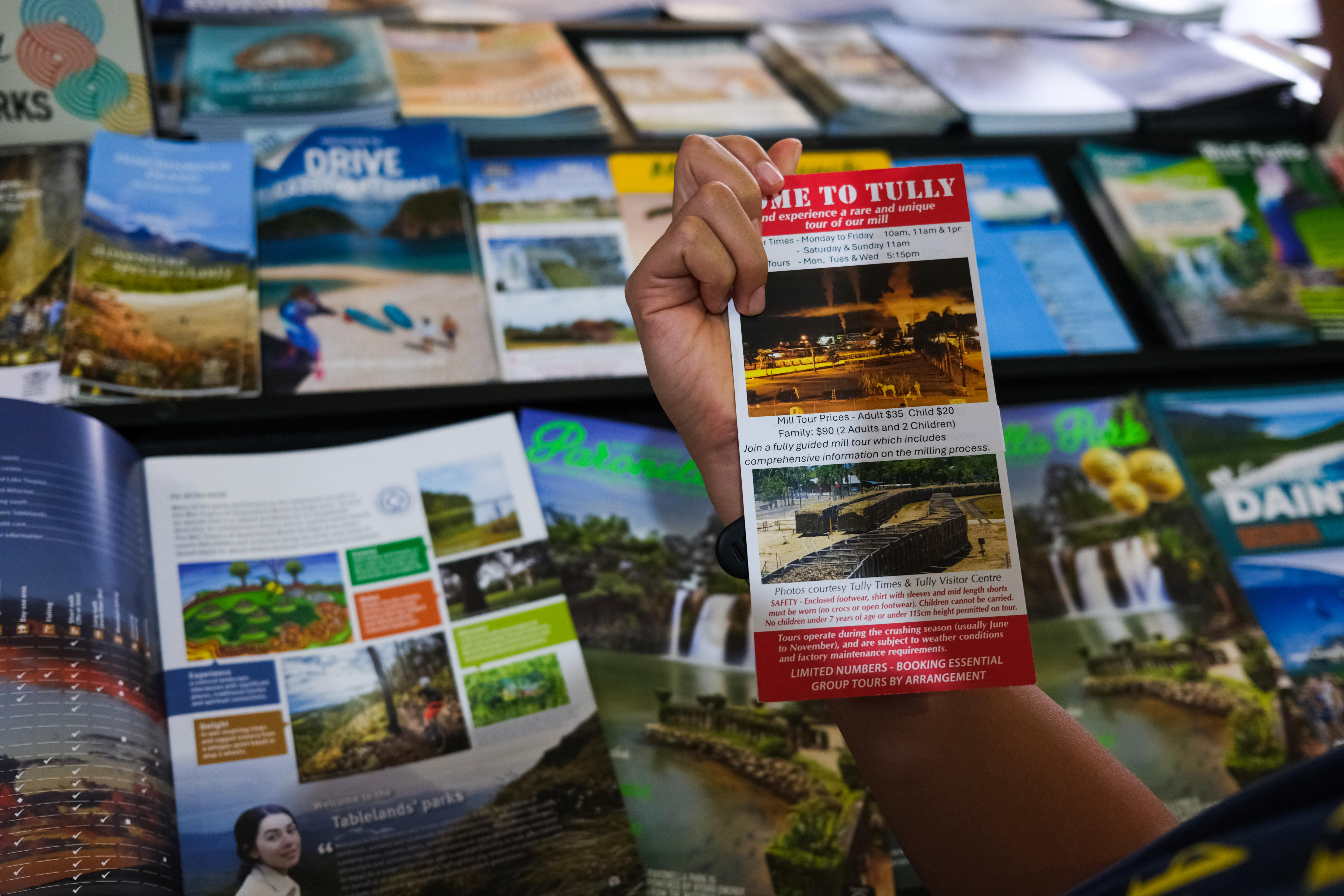 A hand holding a pamphlet