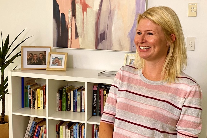 Faye smiles in her living room.