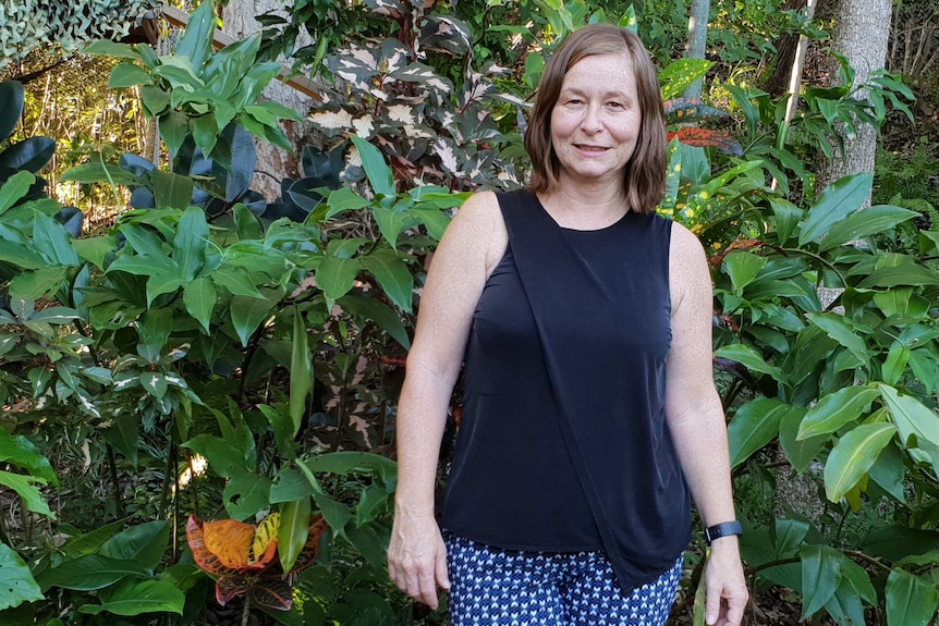 Lisa Law stands in a green garden