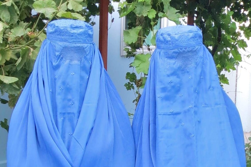 Two women wearing burkas, works as a generic