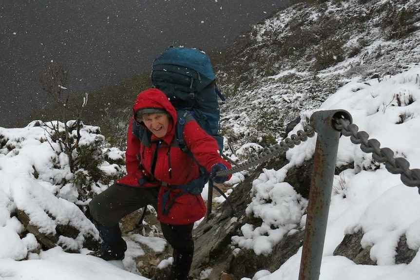 a man in walking gear in thick snow