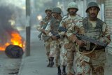 Pakistani paramilitary soldiers patrol a street of Karachi.