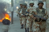 Pakistani paramilitary soldiers patrol a street of Karachi.