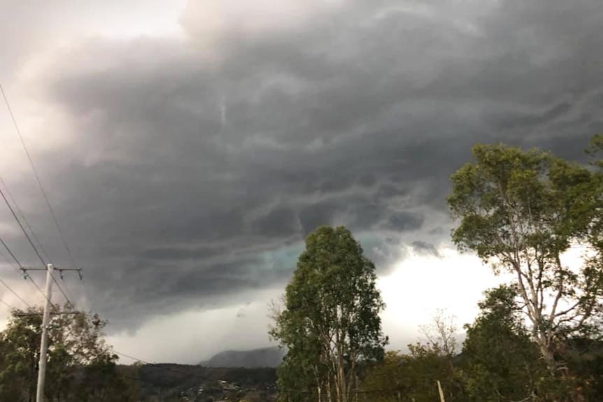 Storm clouds over street and bush at Kooralbyn in Queensland's Scenic Rim on March 15, 2019