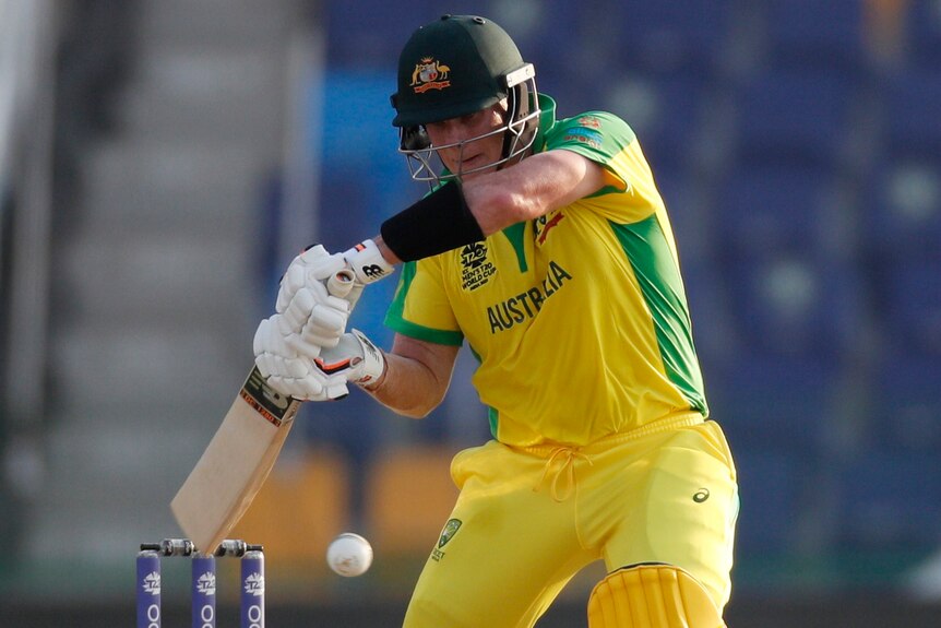An Australian male batter plays a defensive stroke against South Africa at the men's T20 World Cup.