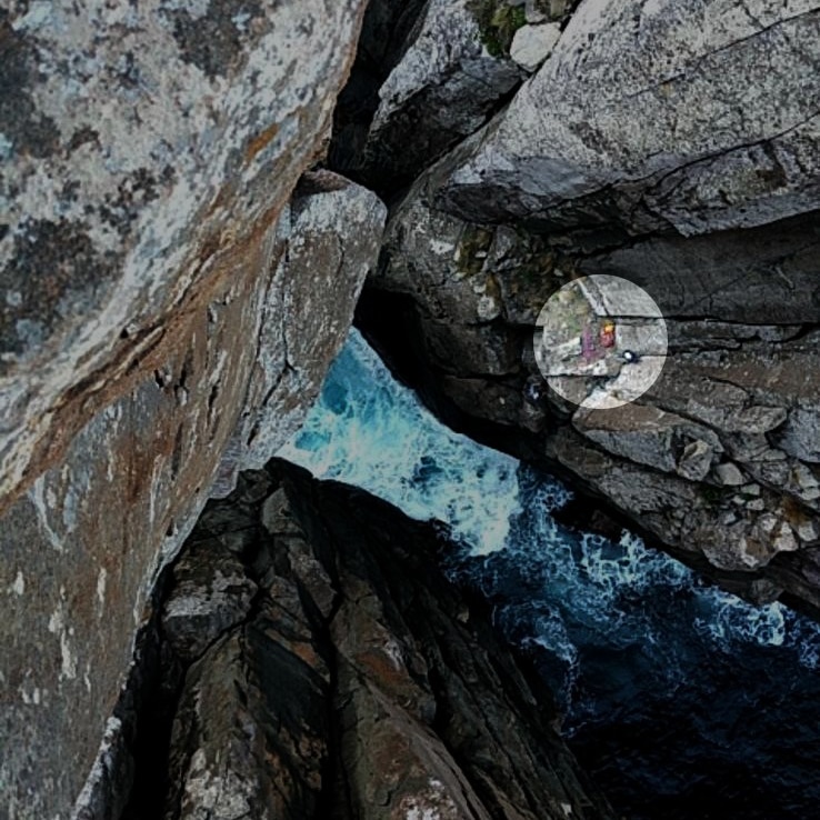 A highlighted area showing two figures on a cliff ledge