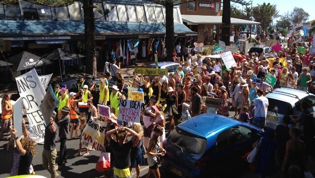 March in March protesters walk through the centre of Byron Bay.