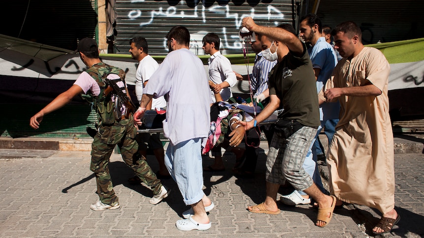 Wounded man carried away amid Aleppo fighting