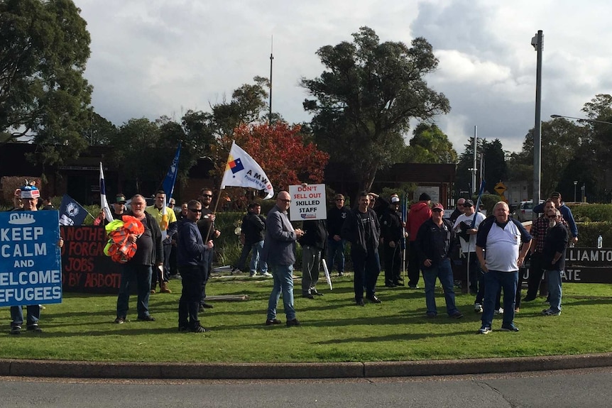 Protesters outside Williamtown RAAF base for the arrival of the Prime Minister, Tony Abbott.