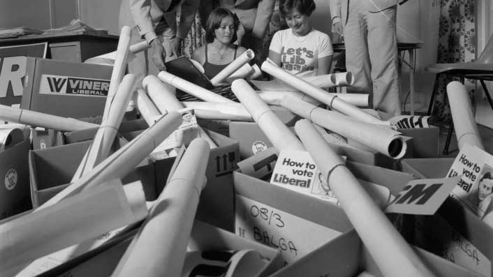 Western Australian liberals surrounded by fliers and poster in1975.