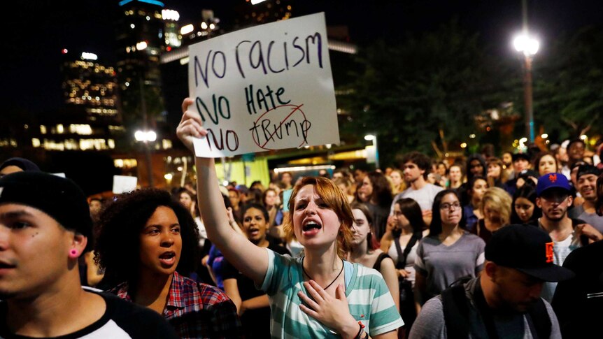 Demonstrators protest outside of City Hall in downtown Los Angeles, California.