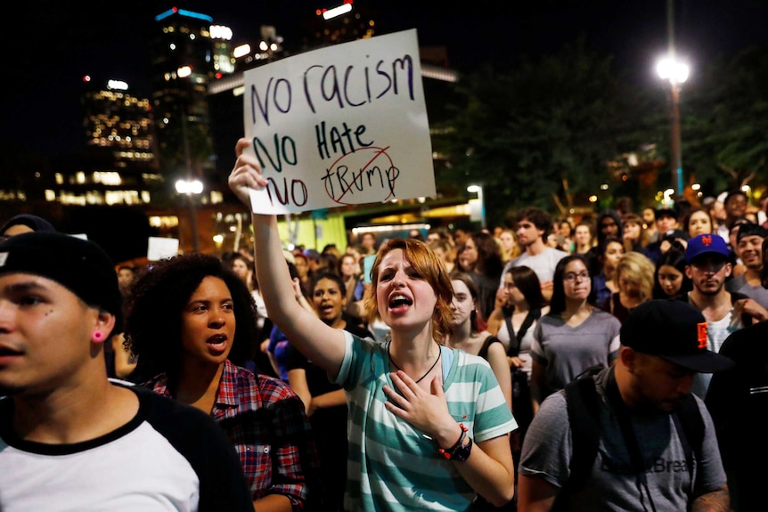 Demonstrators protest outside of City Hall in downtown Los Angeles, California.