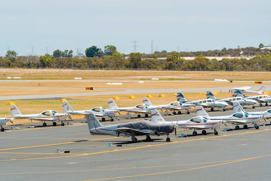 A wide shot of China Southern planes parked on the tarmac at Jandakot Airport in Perth.