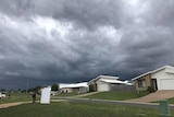 A photo of new houses in a street in Gracemere, with dark clouds in the sky.