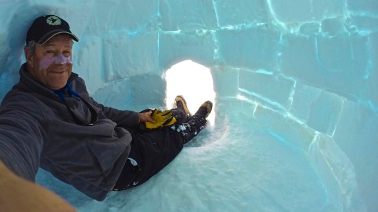 David Wood takes a selfie inside an igloo.