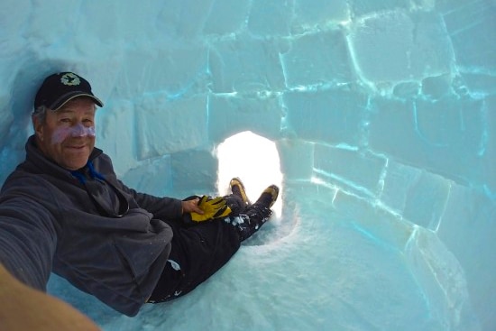 David Wood takes a selfie inside an igloo.