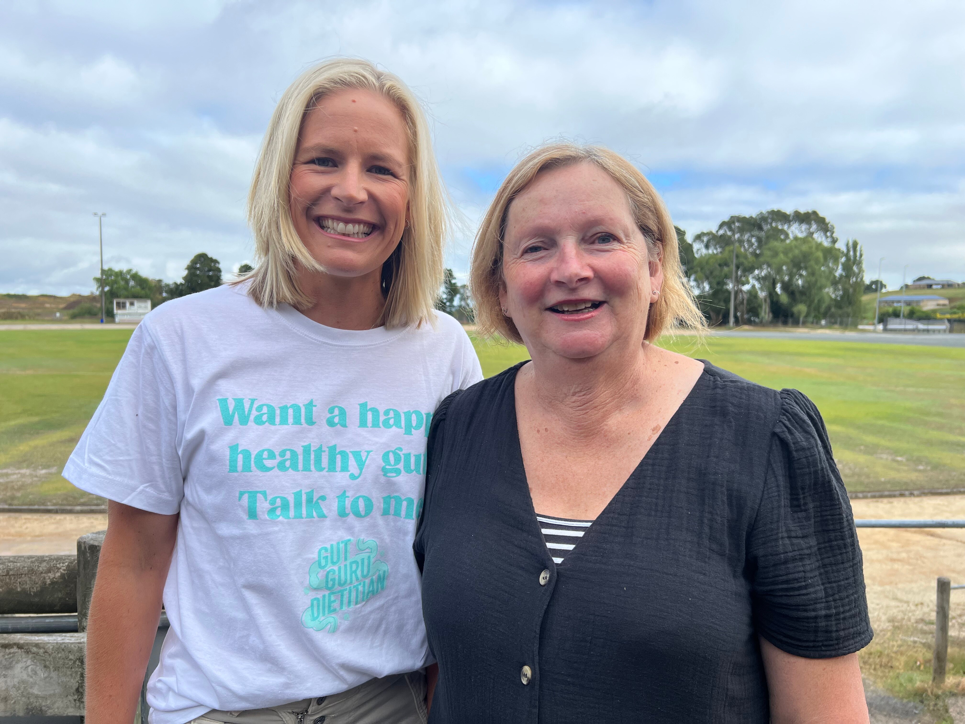 Two women smile at the camera