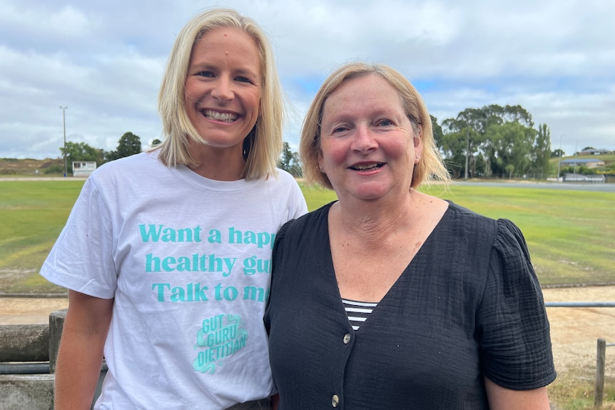 Two women smile at the camera