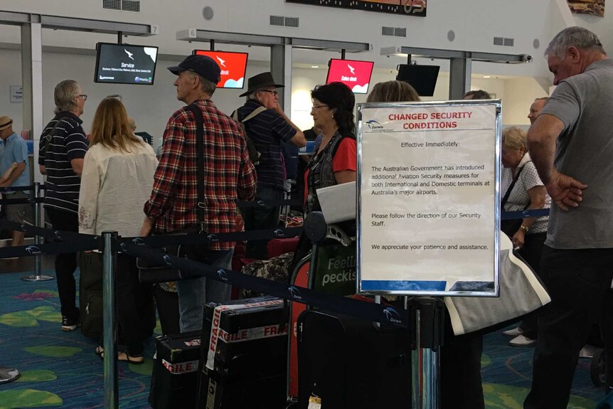 Travellers waiting in line to check in.